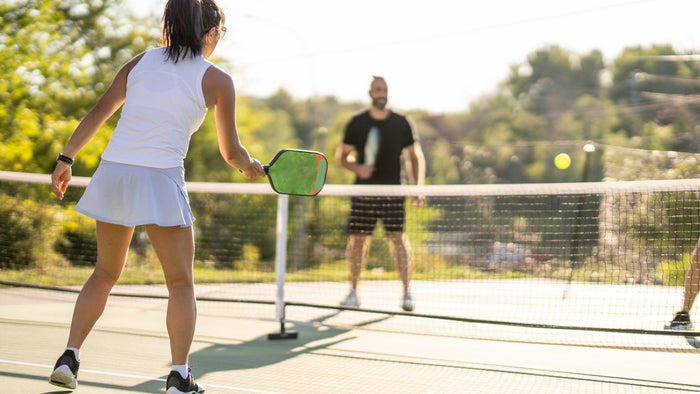 Woman hitting pickleball shot